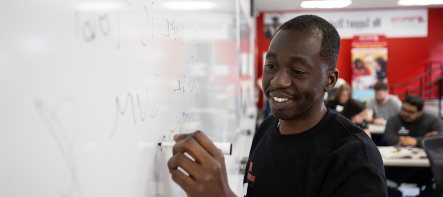 person writing on the whiteboard